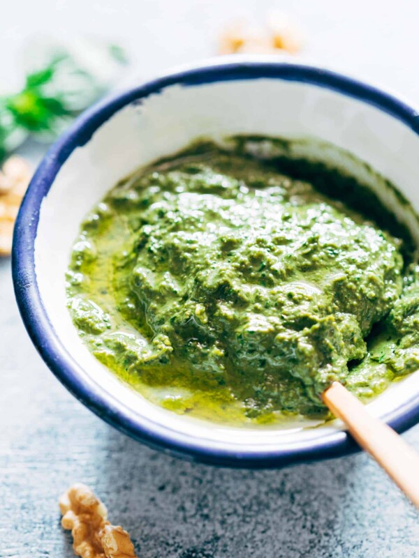 Creamy pesto in a white and blue bowl.