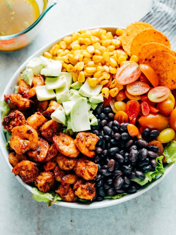 Ingredients of the salad assembled together in a white bowl.