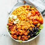Ingredients of the salad assembled together in a white bowl.