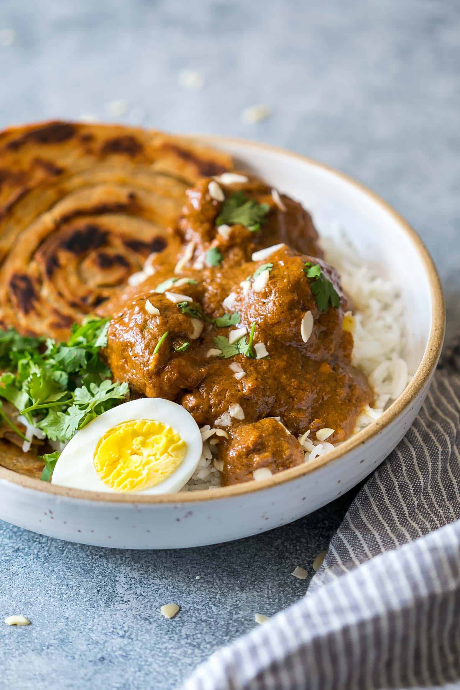 Mughlai Chicken is a restaurant style, north Indian recipe with a creamy, dark brown onion gravy that will have you licking the plate! Serve it with parathas, biryani or jeera rice, and feel free to substitute paneer if you are vegetarian.