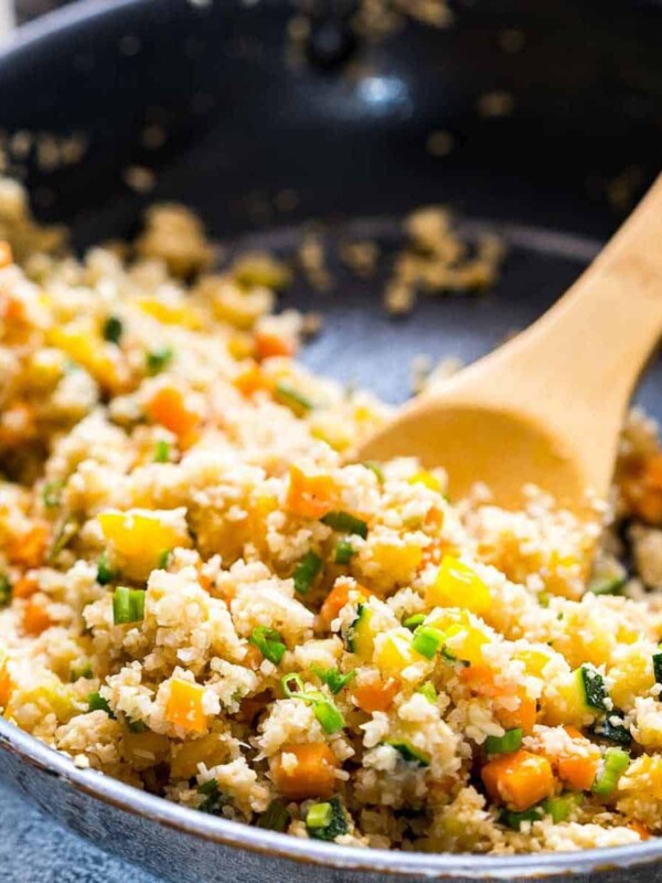 Low Carb Asian Cauliflower Rice being tossed in a pan.