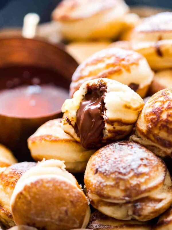 Chocolate Stuffed Mini Pancake Bites served with maple syrup on the side.