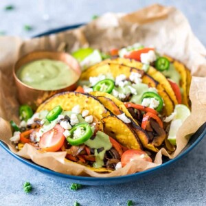 Vegetarian Portobello Mushroom Fajita Tacos served with avocado cilantro sauce on the side.