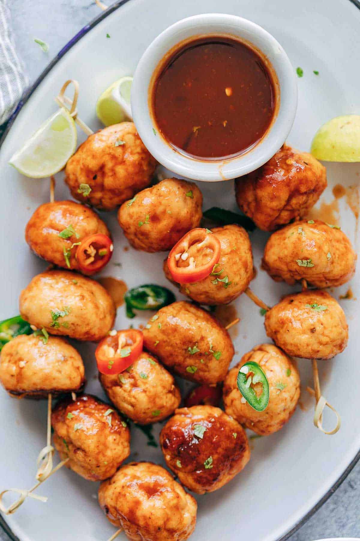 Baked firecracker chicken meatballs are juicy, spicy and saucy! This easy appetizer is perfect for holiday parties. Each meatball is super tender and full of flavour.