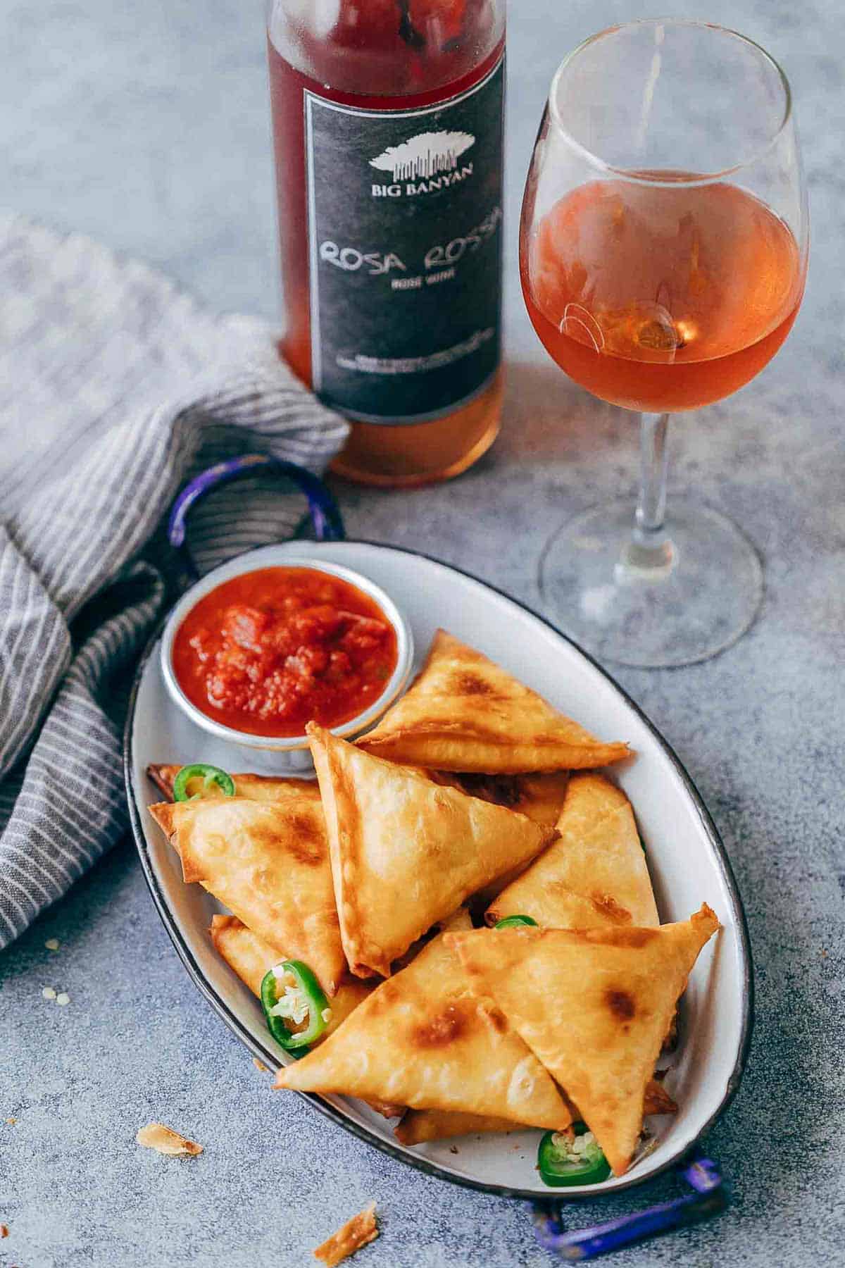 Super cheesy jalapeno three cheese samosa are sure to become a favourite because who can resist gooey stringy cheese stuffed in crispy samosa wrappers! These vegetarian samosas have a filling of mozzarella, cream cheese, smoked cheddar and jalapenos and folding them is really easy too.ย