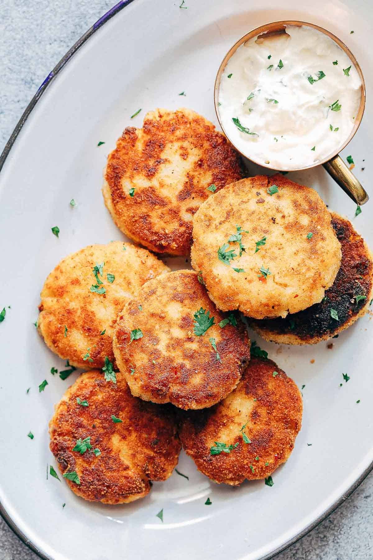 Picture of Leftover Mashed Potato Ham Cakes on a plate with sour cream