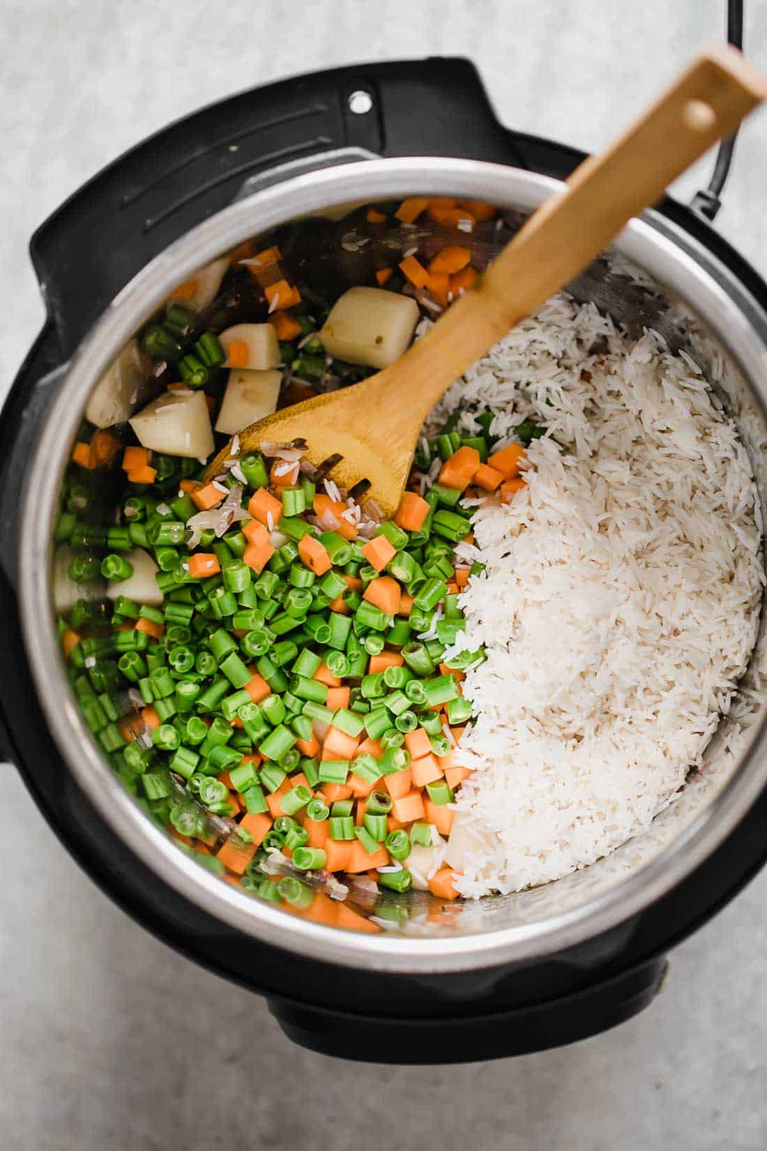 This pressure cooker VEGETABLE PILAF (rice pulao/ pilav) recipe is fragrant, fluffy and perfect every single time! Make this healthy and easy mixed vegetable rice (like biryani) in under 30 minutes. Seasoning includes whole spices and cooked with lots of vegetables, this is the perfect Indian side dish. #sides #recipe #dinner #fast #onepot #vegetarian All the ingredients pictures in the Instant Pot for pressure cooker veg pulao