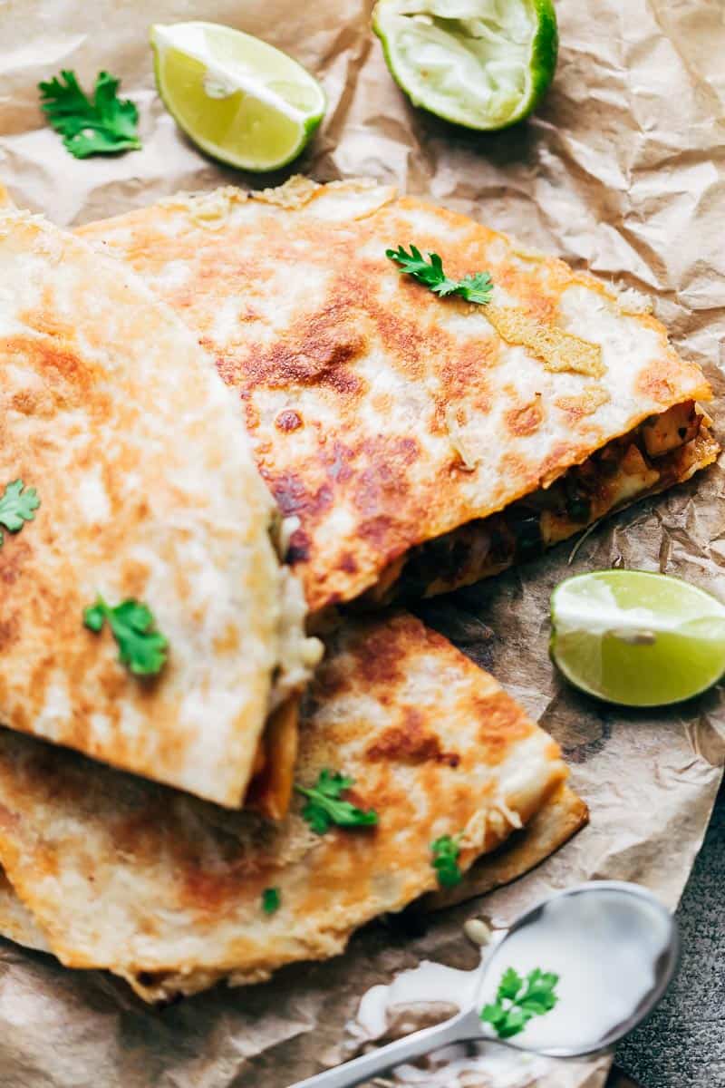 Closeup of chicken fajita quesadilla with crispy bits of cheese stuck to the fajitas