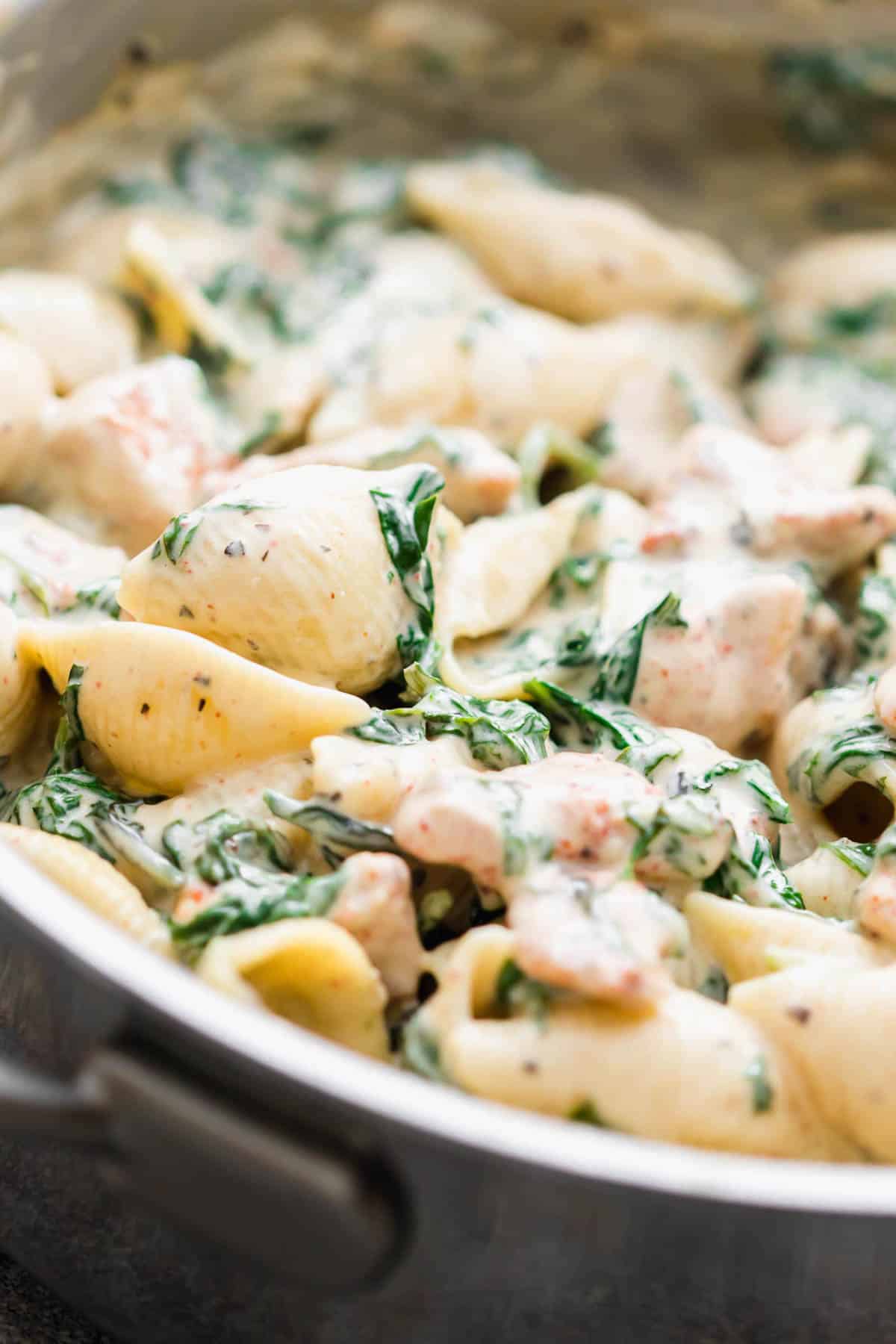 Closeup of creamy chicken florentine pasta in a pan