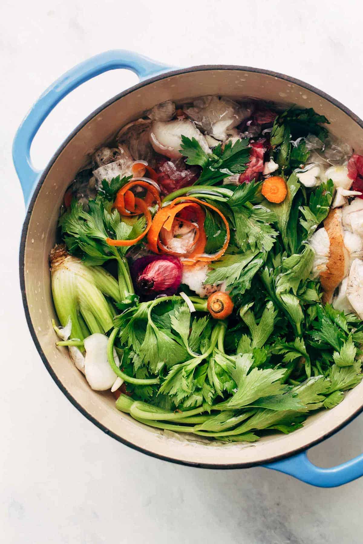 Kitchen scraps and spices in a big pot with water ready to make vegetable stock