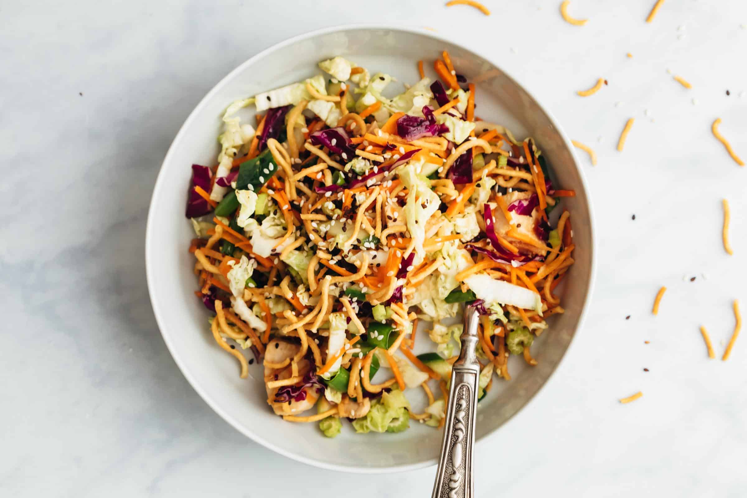 Crunchy Chinese chicken salad served in a bowl with a fork