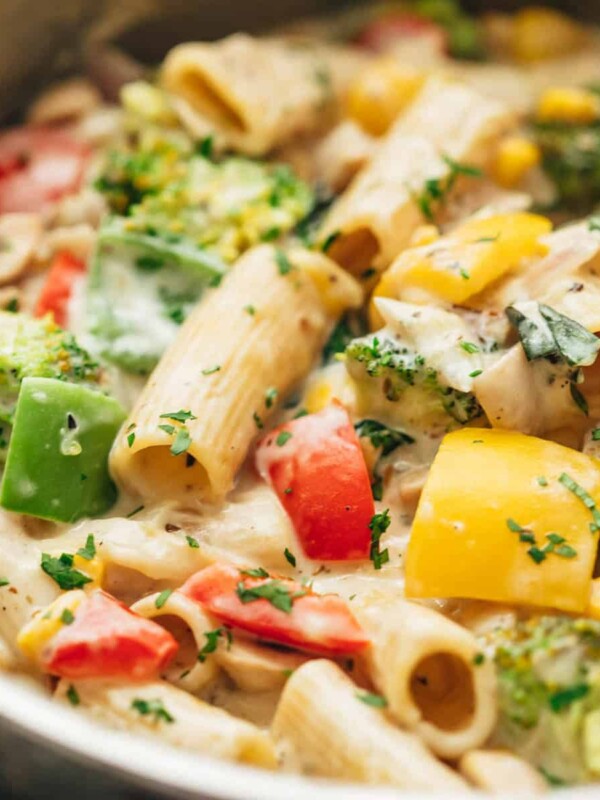 White sauce pasta with vegetables directly from the stovetop in a pan.