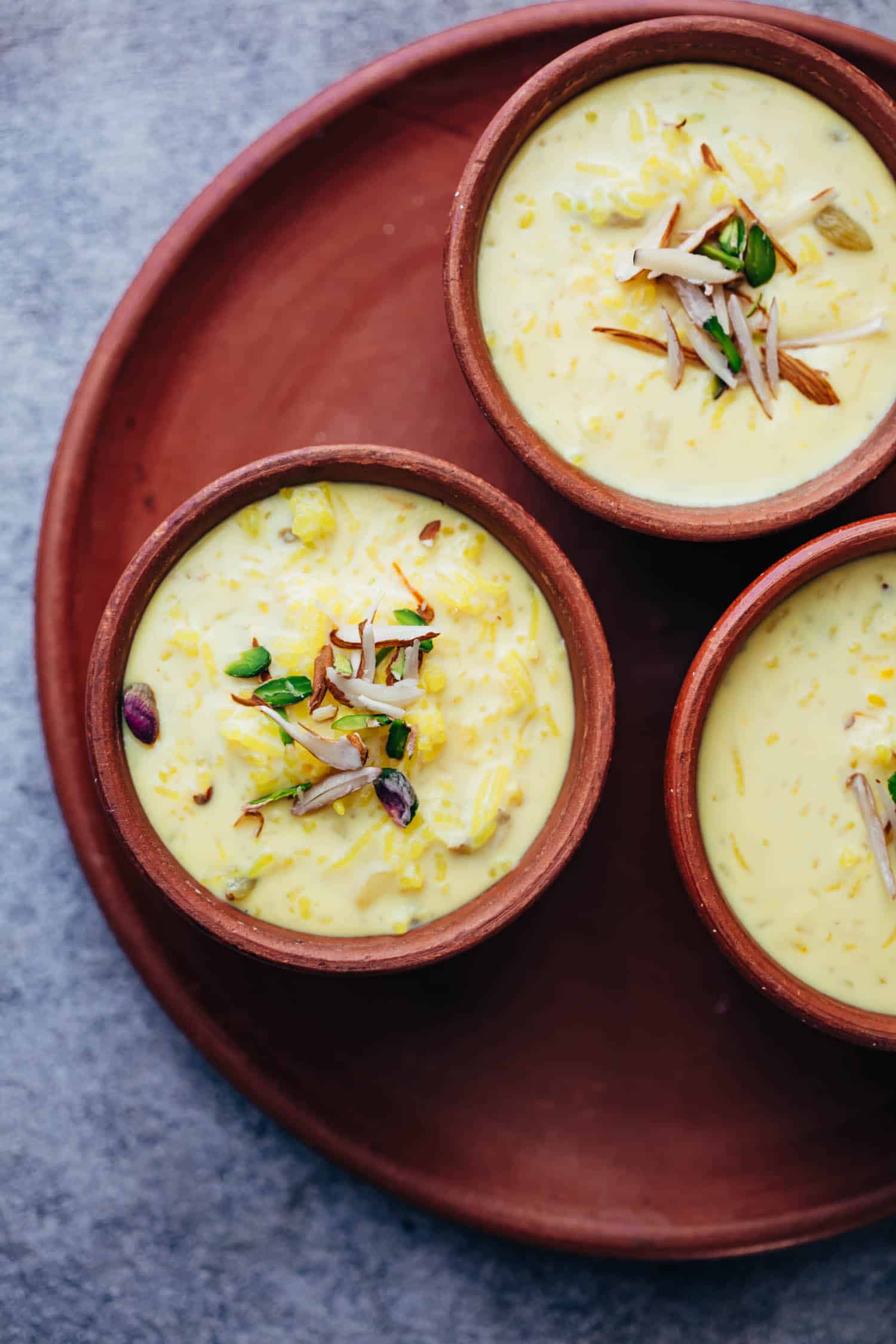 Overhead shot of rice kheer in mud pots