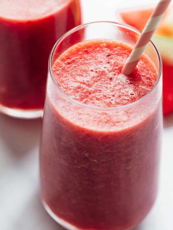 Two glasses of watermelon lime smoothie with paper straws