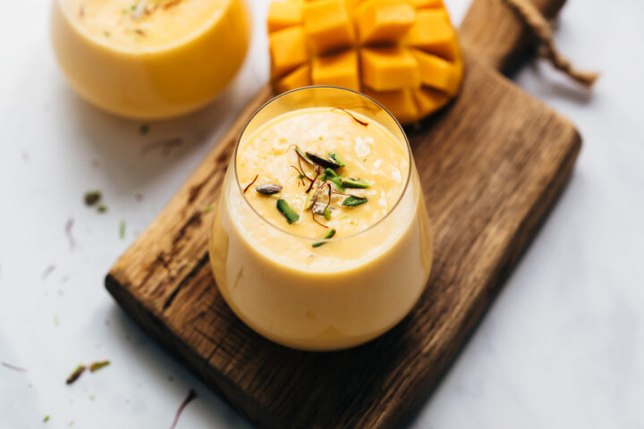 Two glasses of thick and creamy mango lassi
