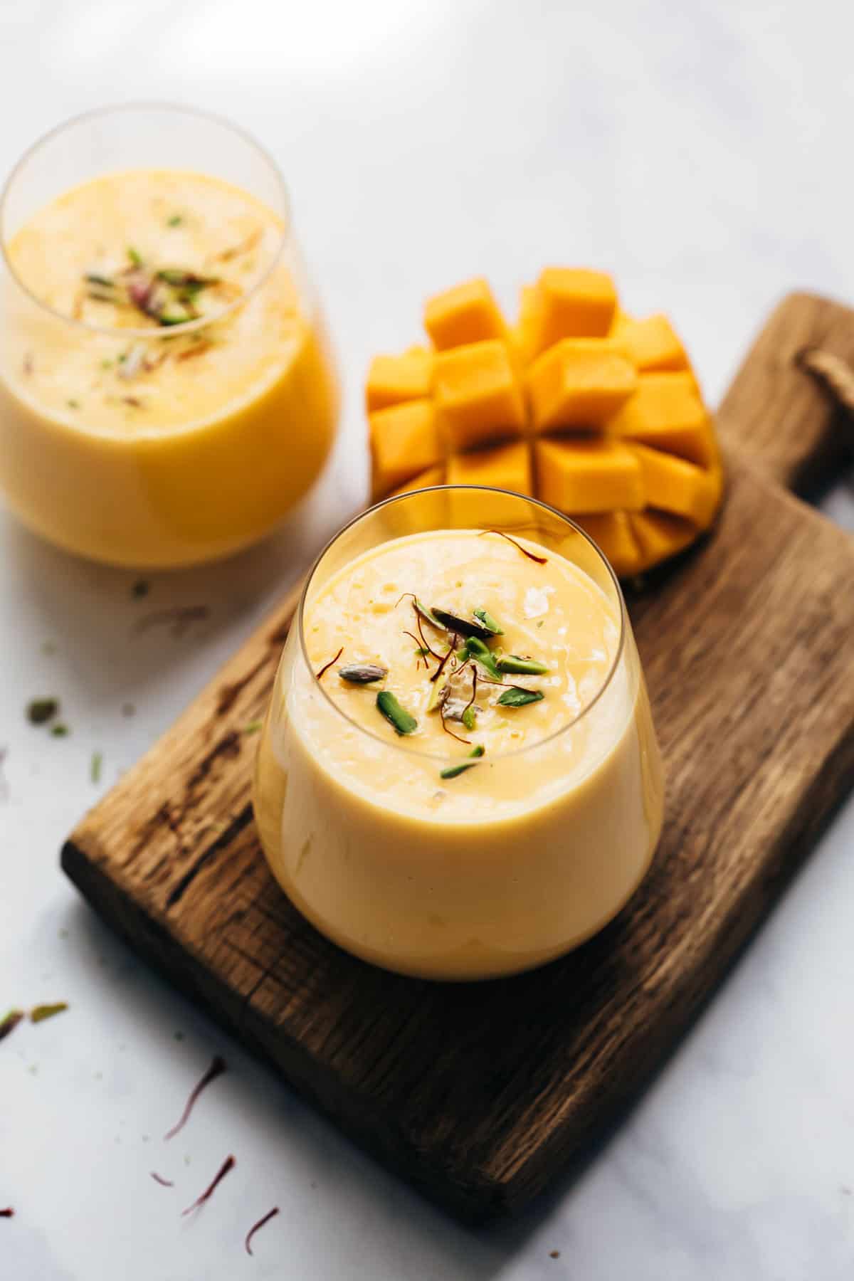 Two glasses of thick and creamy mango lassi