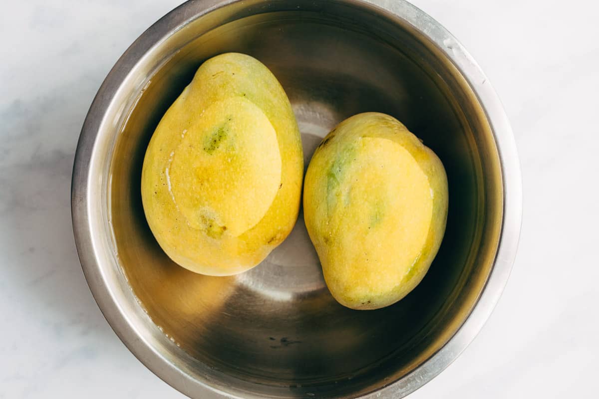 Mango being soaked before it is cut.
