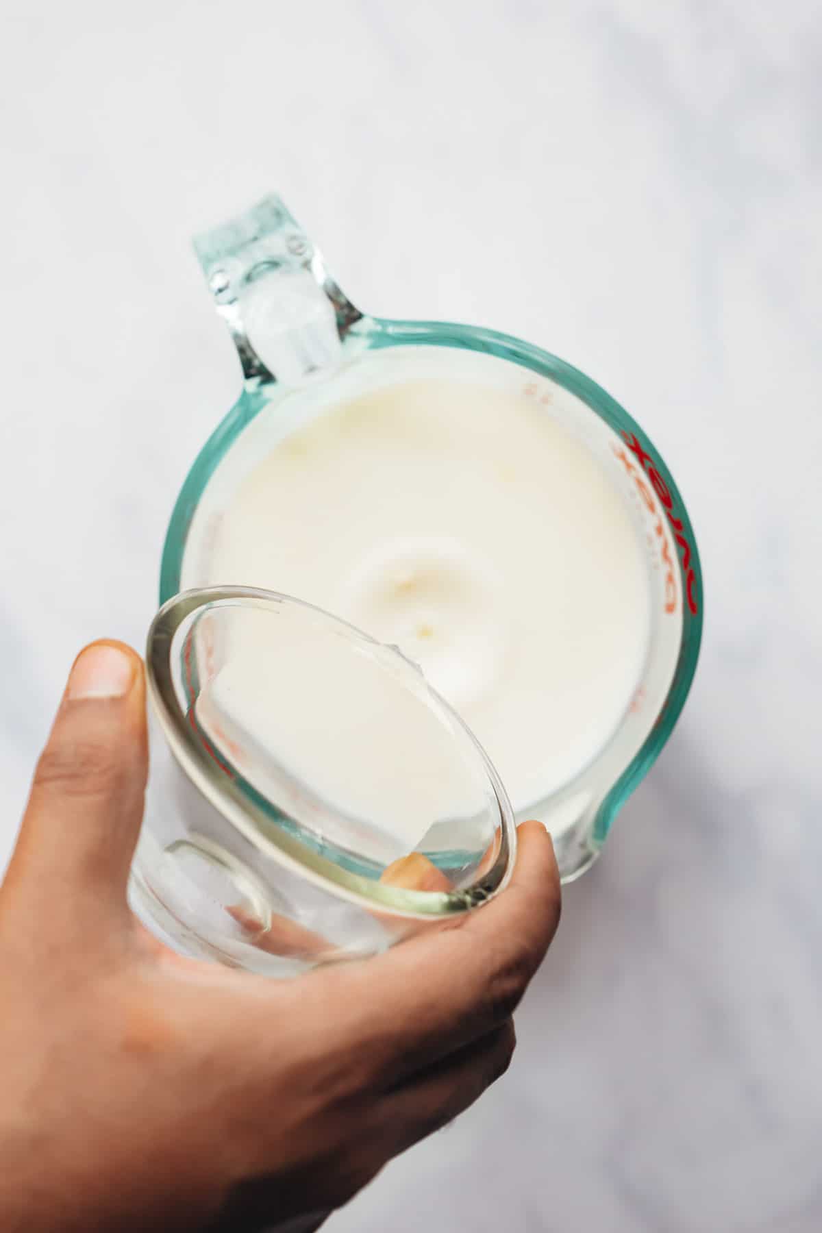 Adding vinegar to milk for making buttermilk.