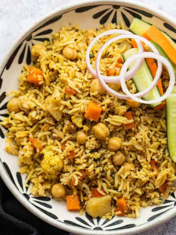 Kabuli Chana Pulao served in a bowl with onions and a salad
