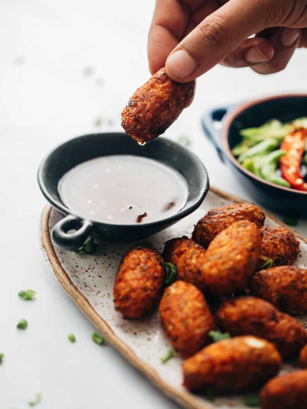 Dipping crispy veg nuggets in sichuan sauce