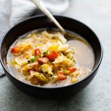 Detox cabbage soup served in a black bowl