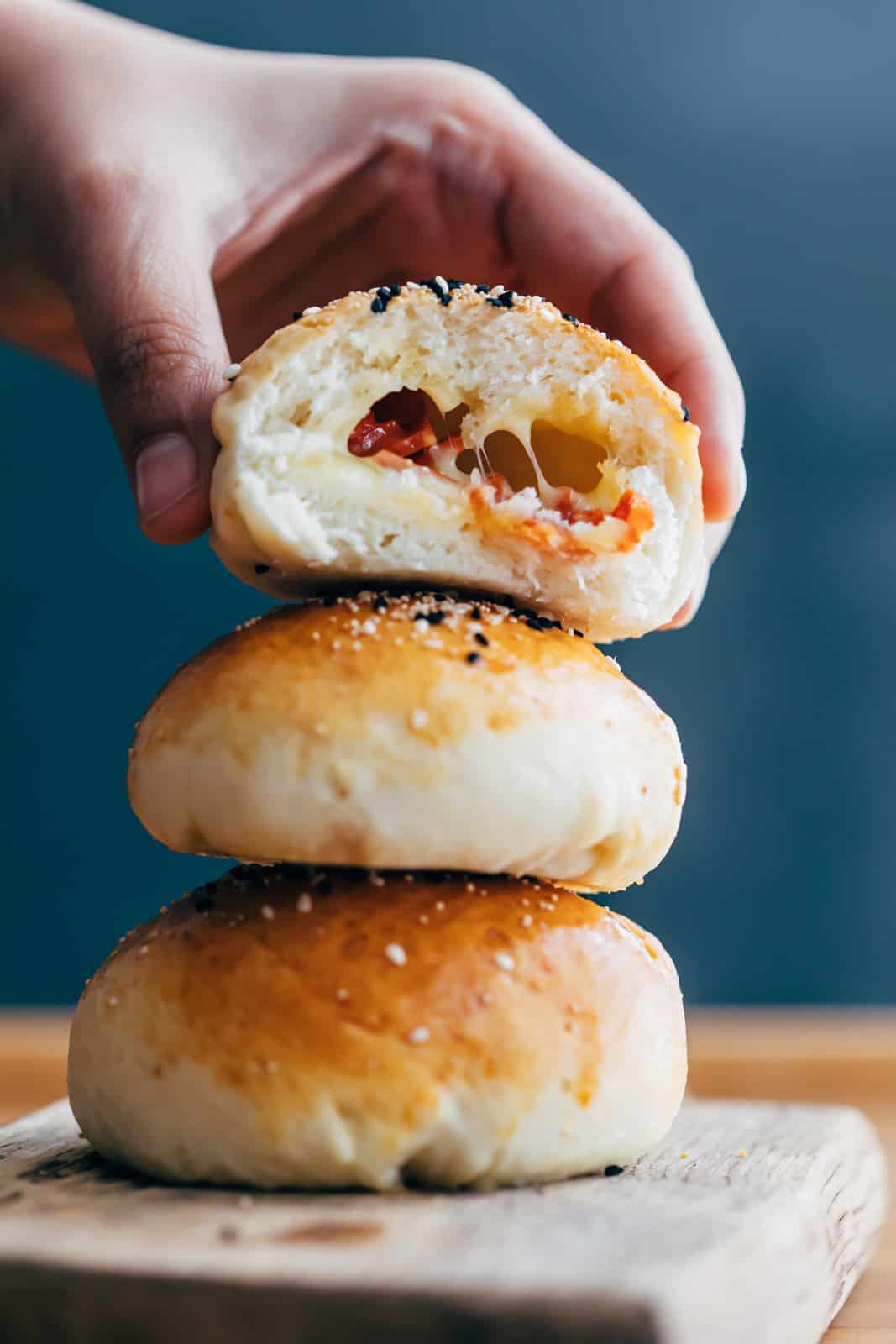Bite shot of pepperoni cheese bombs showing the stuffing