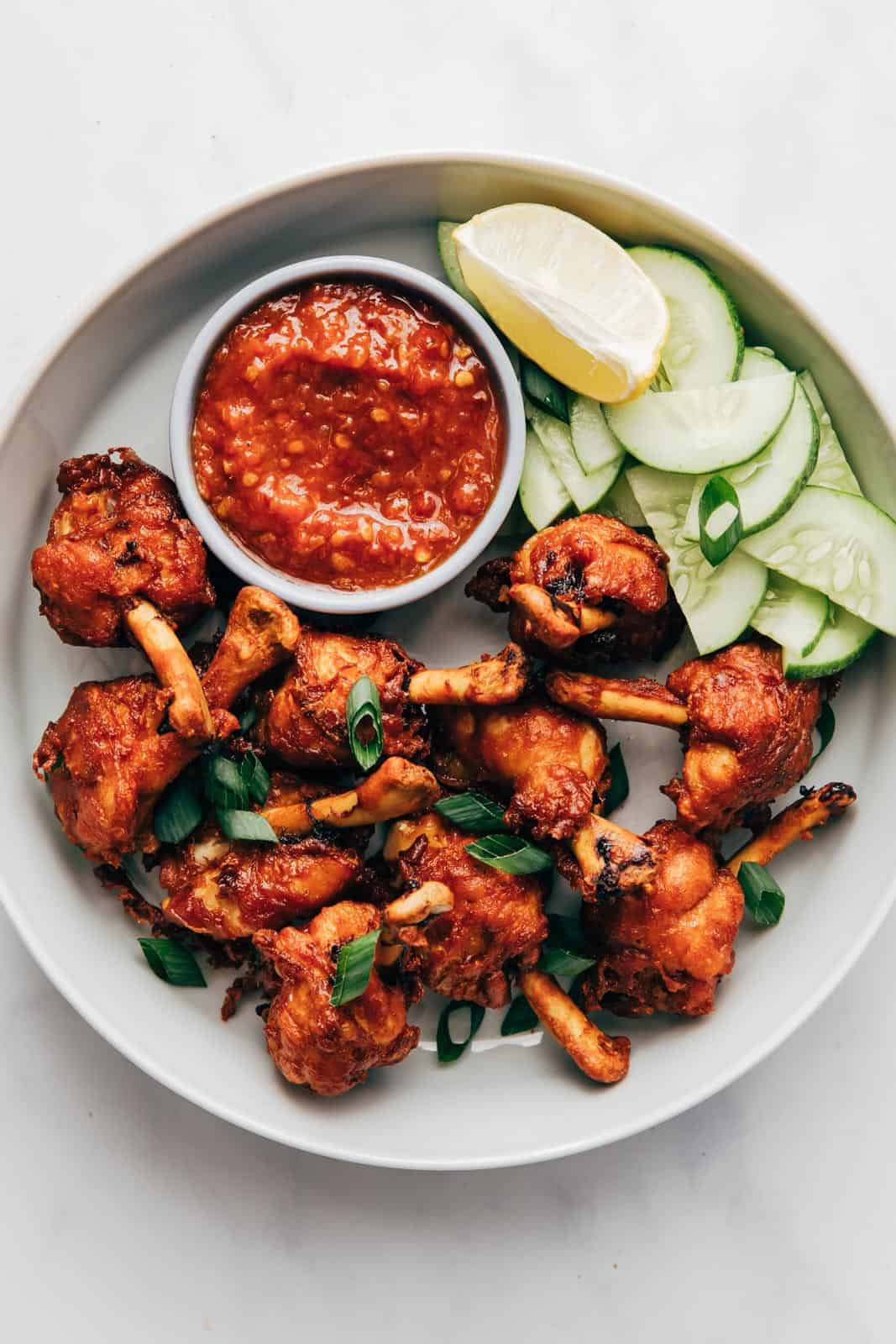 Fried chicken lollipops ready to be served with schezwan sauce
