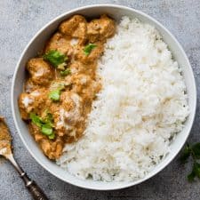 Easy chicken korma served in a bowl with rice