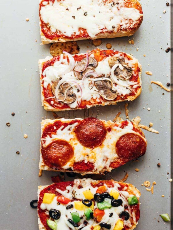 Toasted french bread pizza toasts straight from the oven on a baking sheet