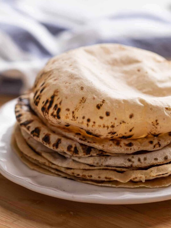 Soft puffy rotis stacked on a plate