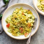pasta in jalapeno pesto served in a white pasta bowl with a fork