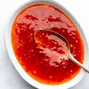 Thai sweet chili sauce served in a bowl with a spoon in it