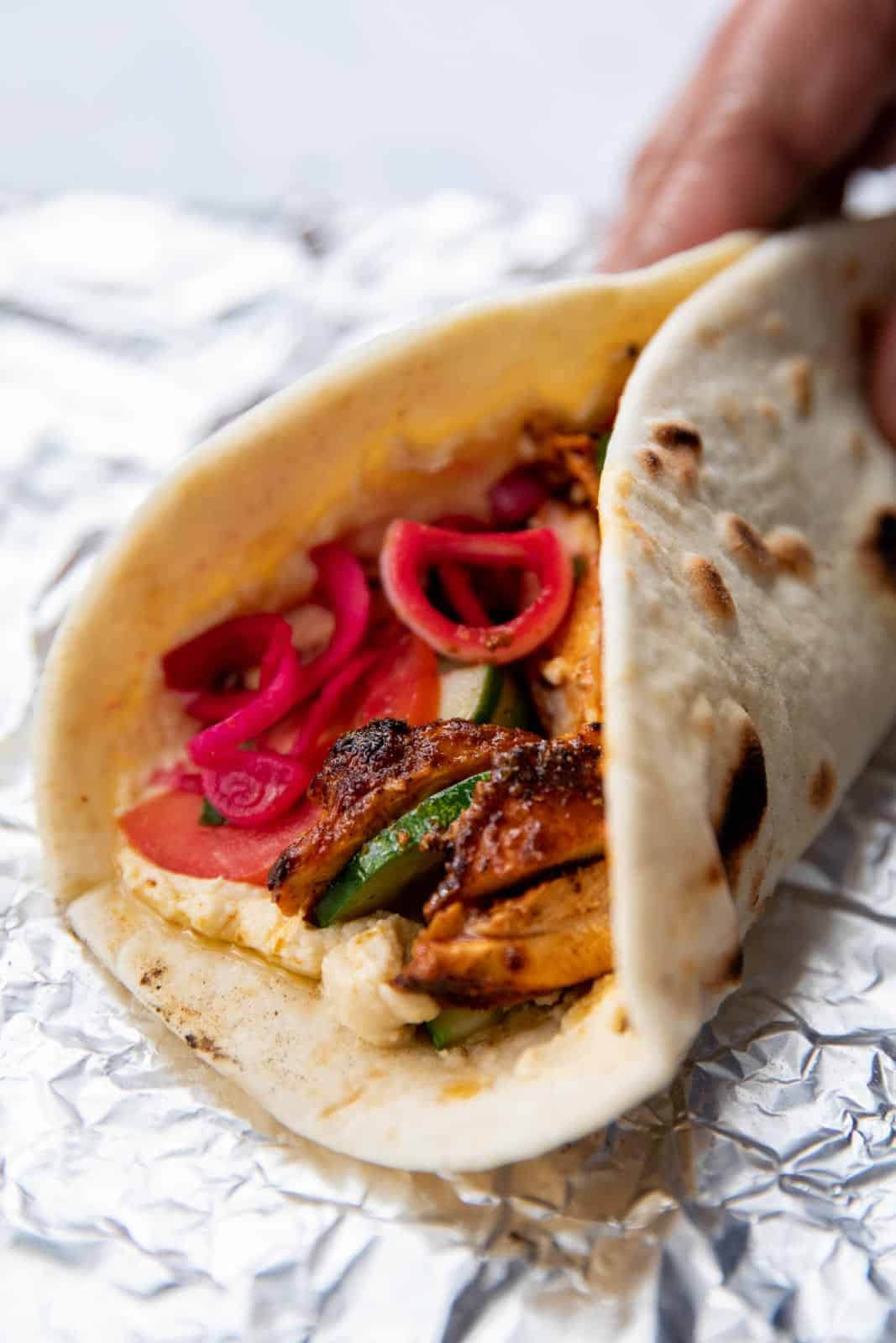 Chicken shawarma wrap waiting to be picked up and eaten