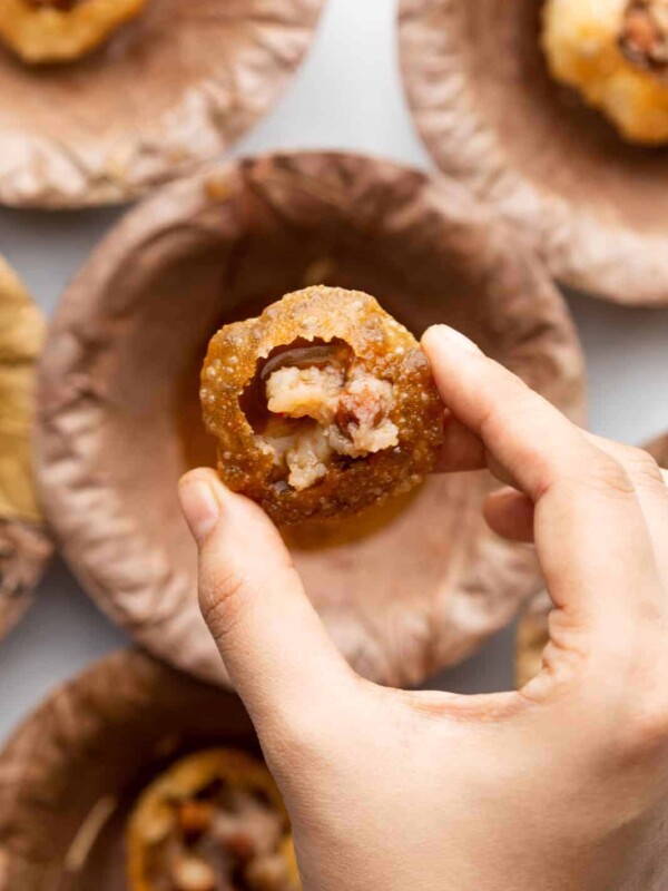 Closeup of a hand picking up pani puri