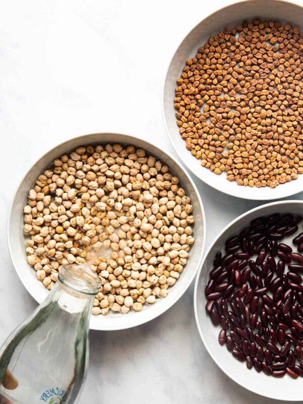 Pouring water into a bowl to soak beans