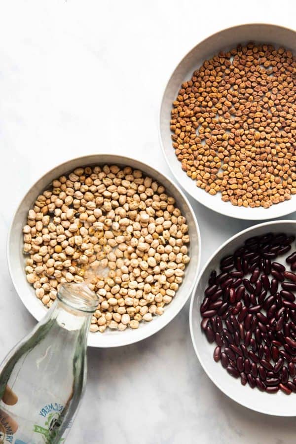 Pouring water into a bowl to soak beans