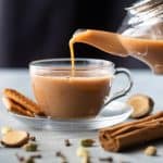 Ginger Chai being poured into a cup from a kettle