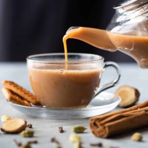 Ginger Chai being poured into a cup from a kettle