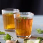 Sulaimani Chai served in small chai glasses with mint and lemon