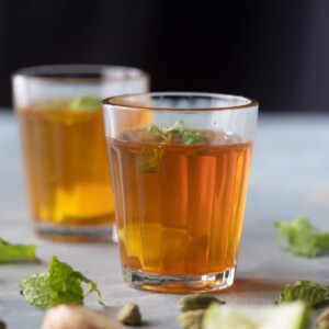 Sulaimani Chai served in small chai glasses with mint and lemon