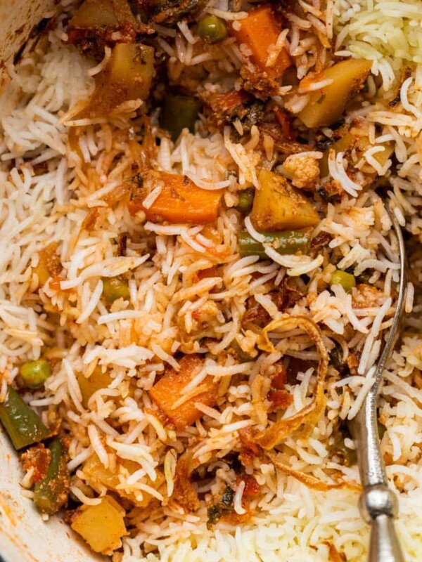 Closeup of veg biryani in the pot after a few spoonfuls have been served