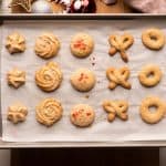 Two hands holding an entire tray of danish brown butter cookies