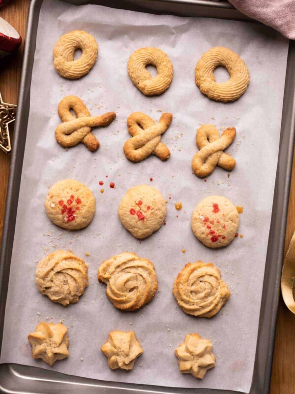 An entire baking tray full of danish brown butter cookies with five different cookie shapes