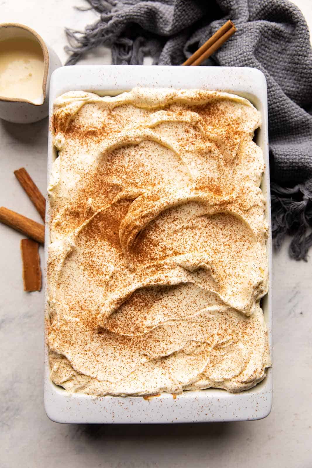 Overhead shot of eggnog tres leches in a baking dish ready to be served