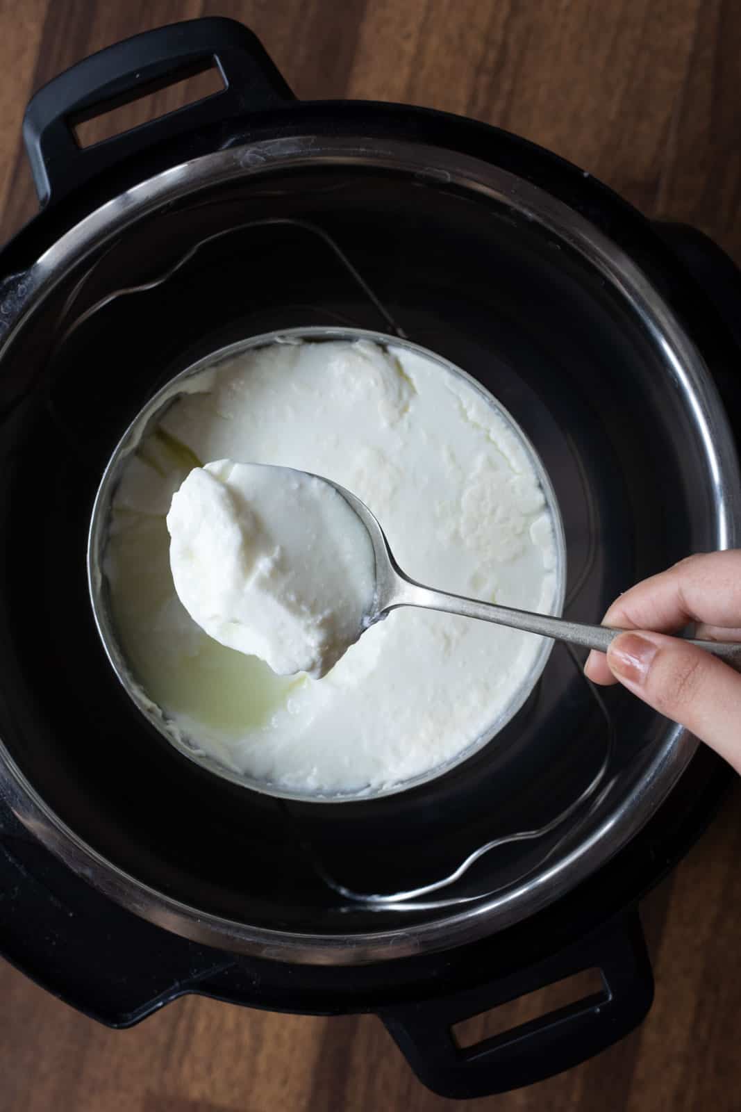 Pot in pot method used to make yogurt in the Instant Pot. Picture showing the consistency of yogurt made using this method