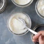 A spoon cutting into the yogurt to show the thick consistency of yogurt