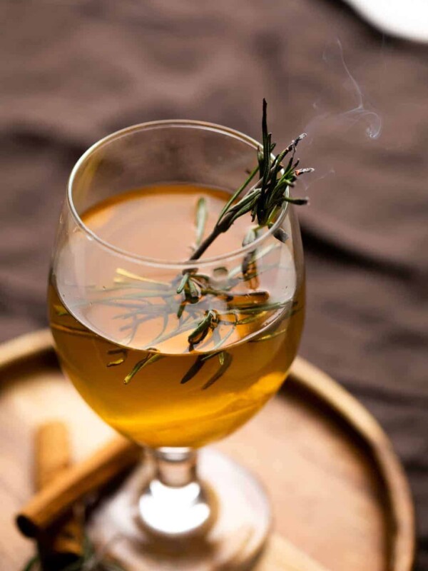 Hot toddy served in a short stemmed glass on a brown plate