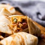 Paneer kathi roll cut into pieces and stacked on top of the other