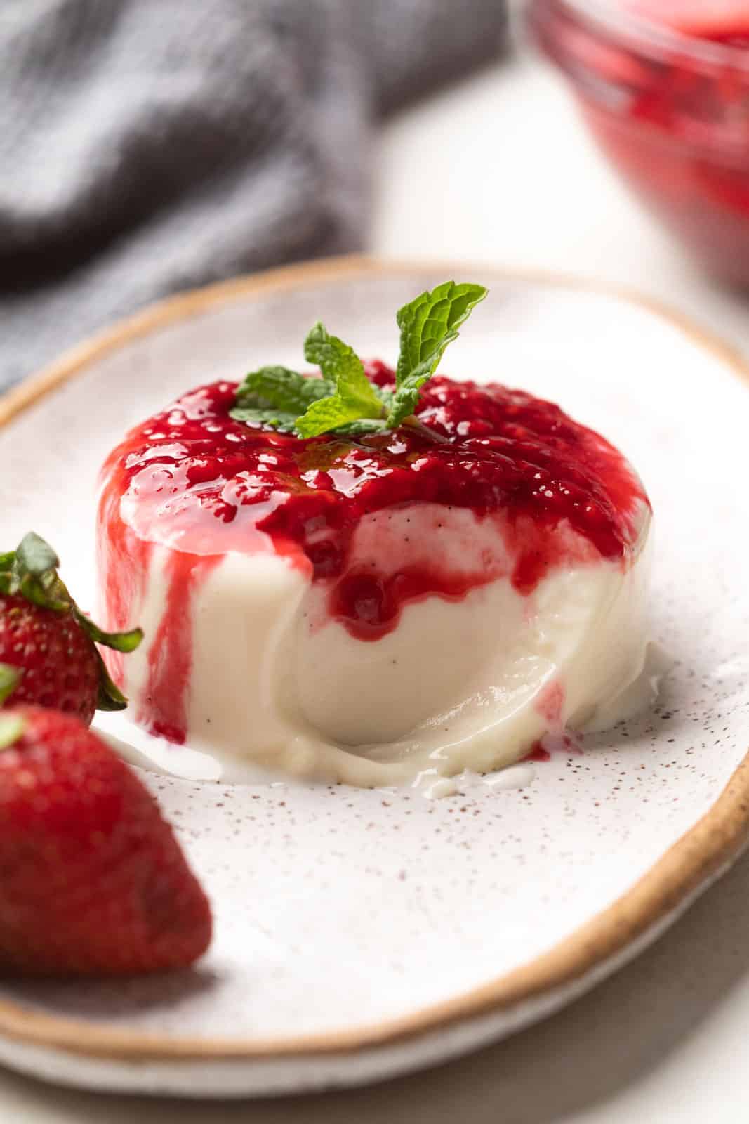 Picture of panna cotta on a plate with a bite taken out of it