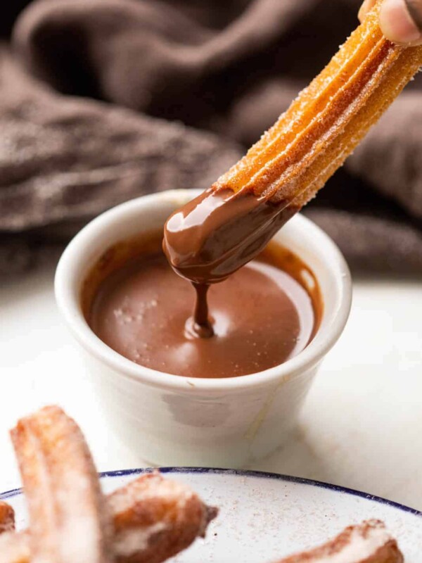 Dipping a churro in chocolate sauce